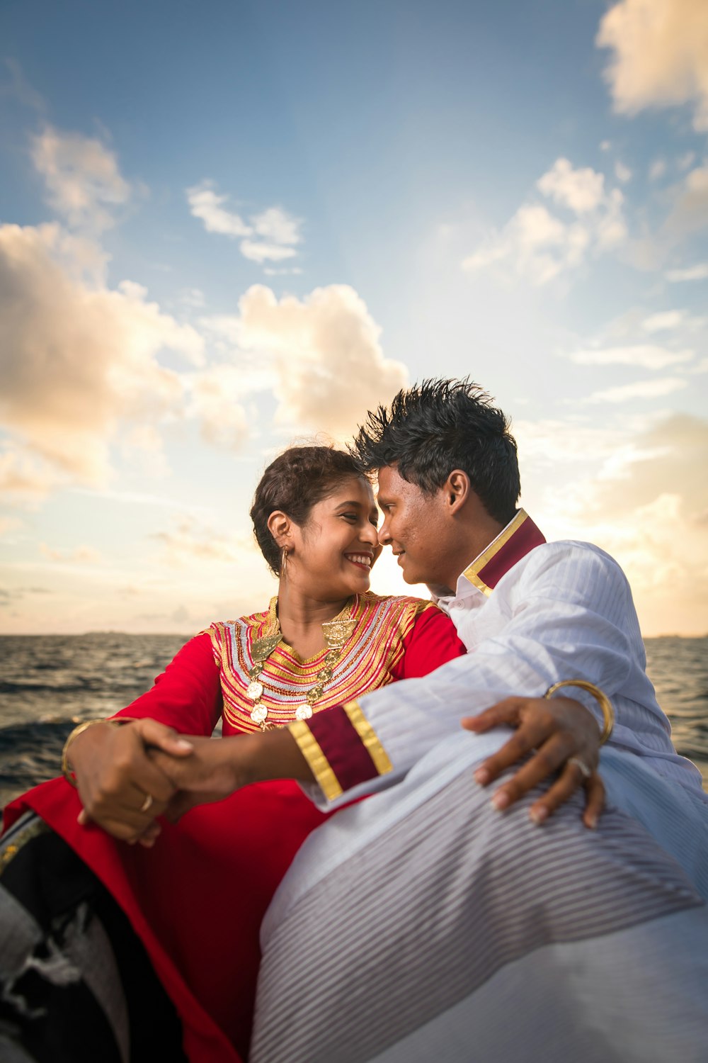 woman and man sitting together near sea