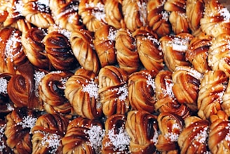 Photo of freshly baked filled brioches lined up on a factory conveyor belt.