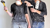 man and woman holding sledgehammer and paint roller