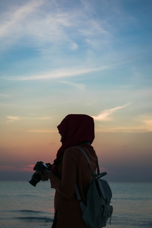 Traveler with a camera and backpack at golden hour