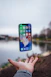 silver iPhone X floating over open palm