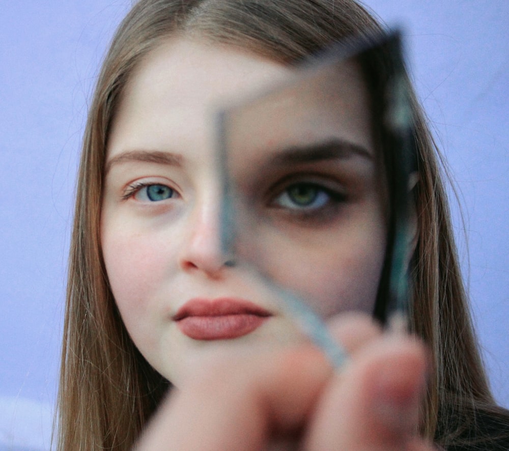 woman holding glass piece