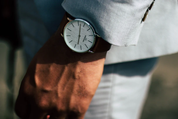 Stylish Lee Cooper watch worn on a wrist, paired with a black suit sleeve.