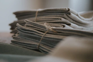 A stack of neatly folded homemade basketball nets ready to ship.