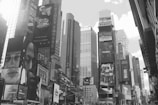 An outdoor view of a bustling city street with advertising billboards.