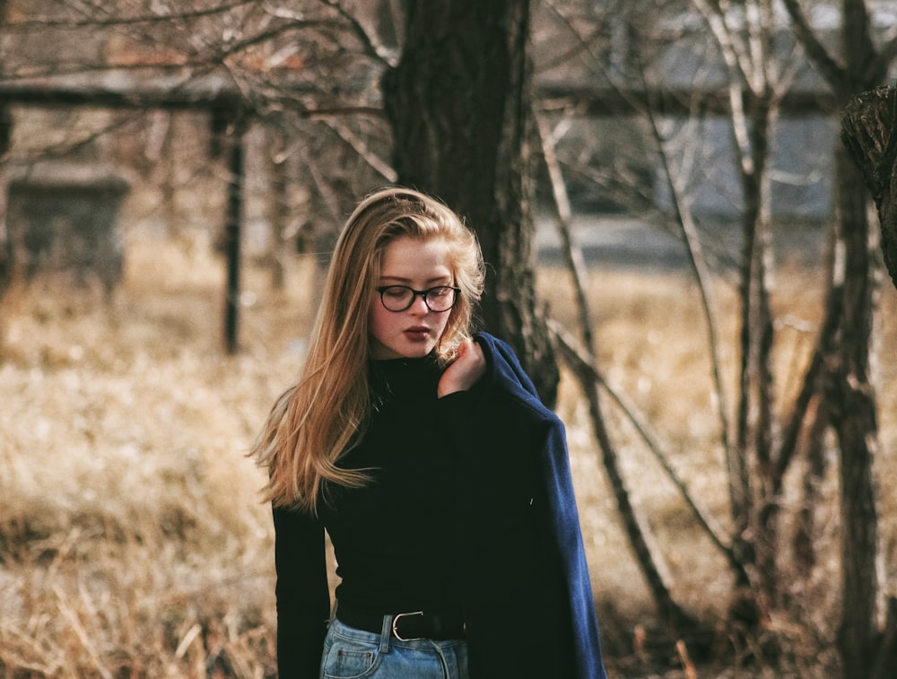 woman wearing black sweater holding her coat