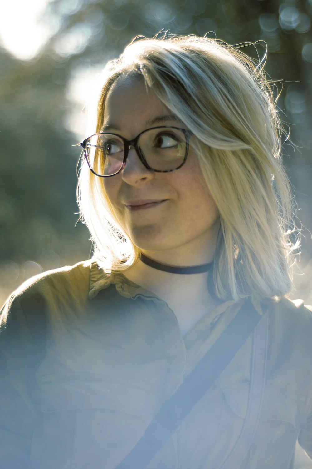 woman wearing eyeglasses with black sling bag