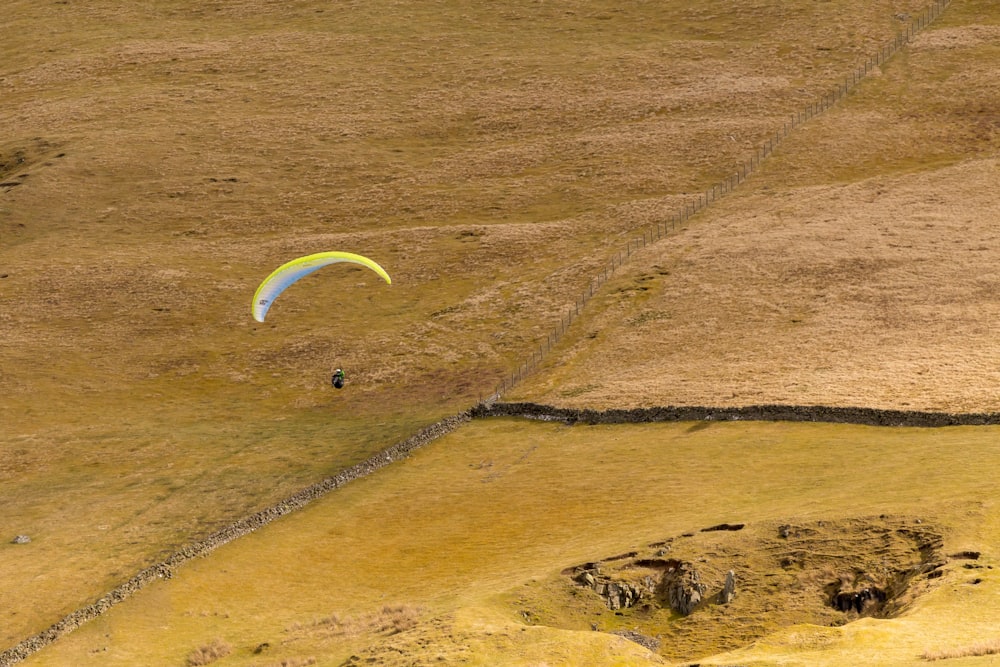 aerial photography of person gliding parachute