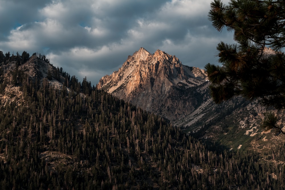 brown mountain under cloudy sky