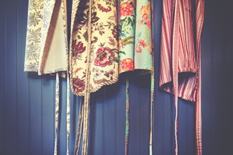 four assorted-color aprons