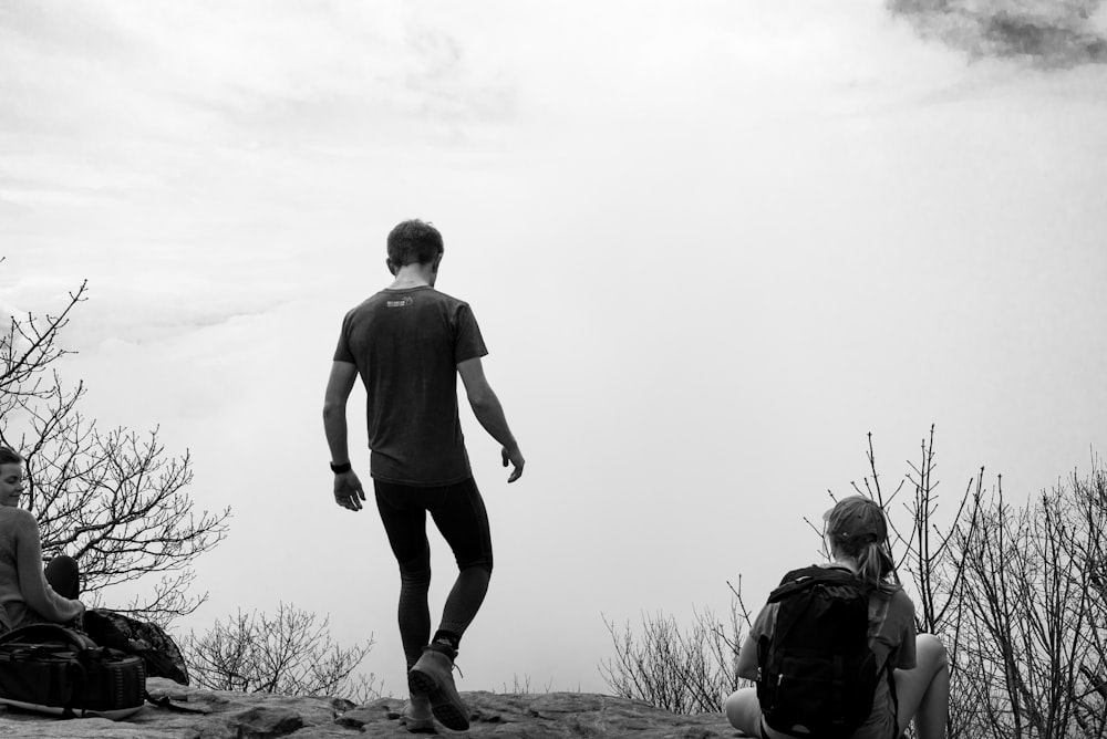 man walking near bare trees