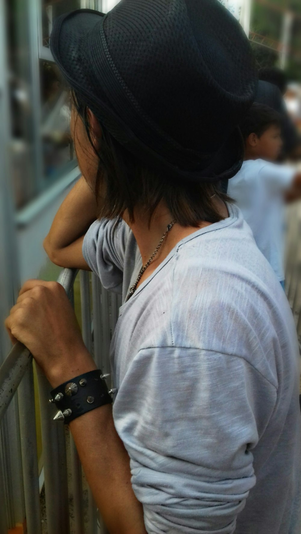 man standing beside fence