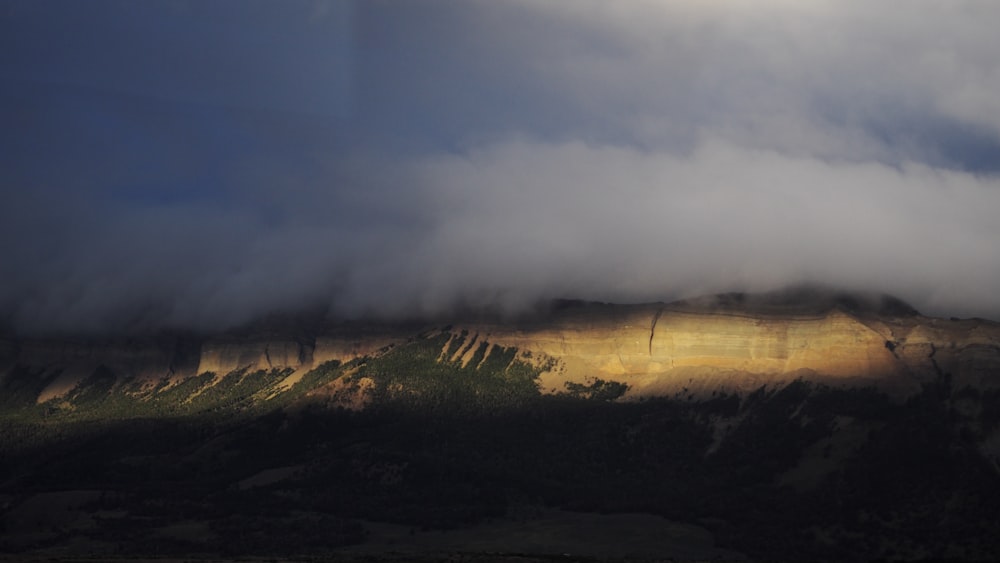 aerial photography of mountain under cloudy sky