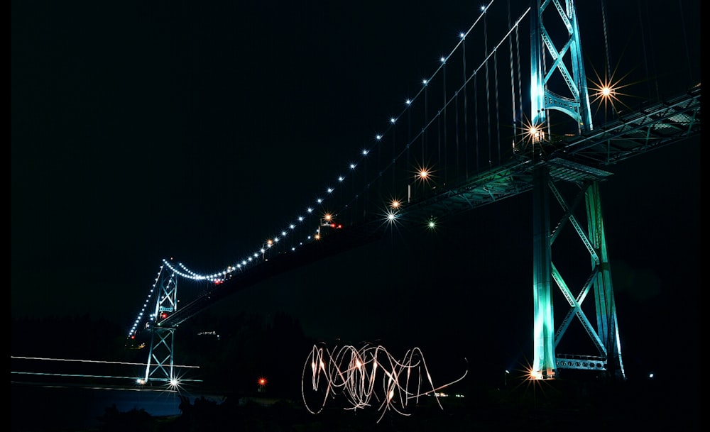 low angle photography of lighted cable bridge