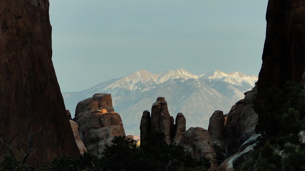 white snow on mountains behind canyon