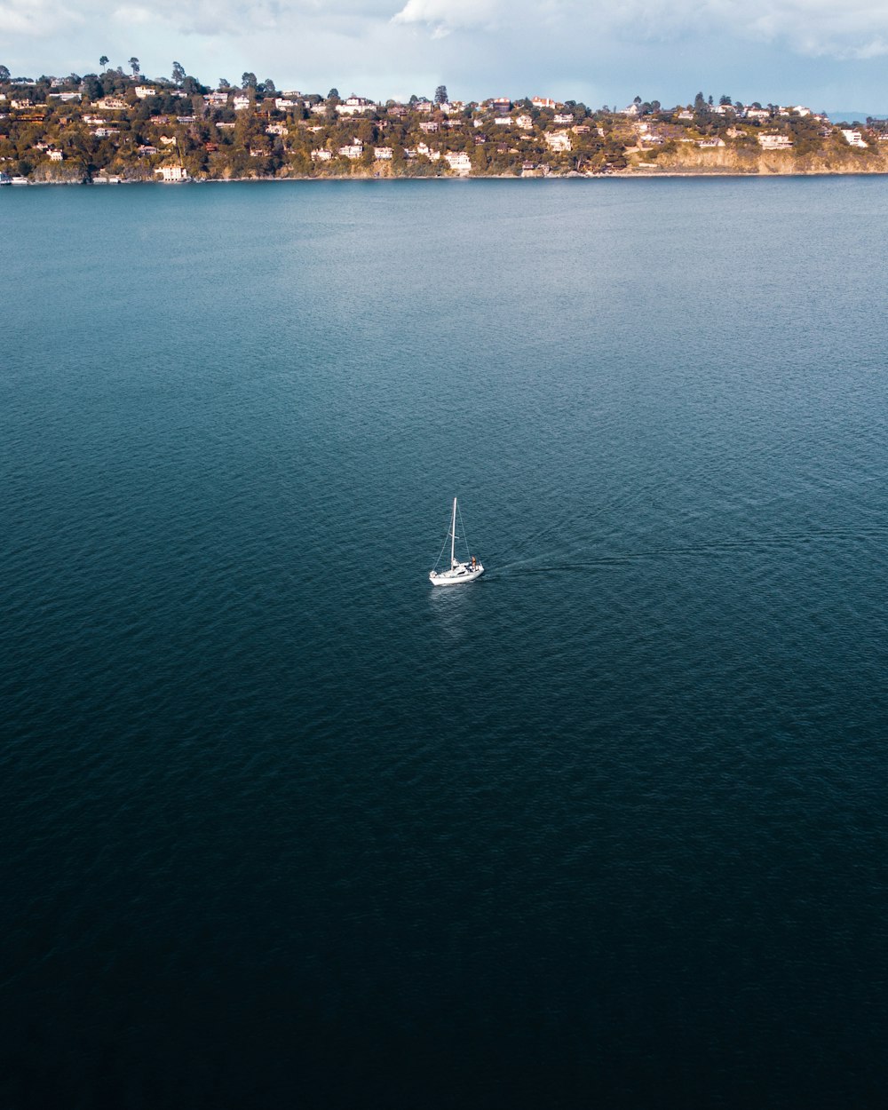 a small boat floating on top of a large body of water