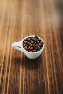 round white ceramic mug with coffee beans