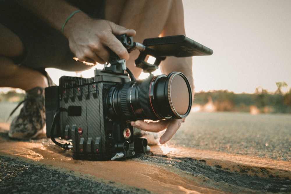 person using professional video camera