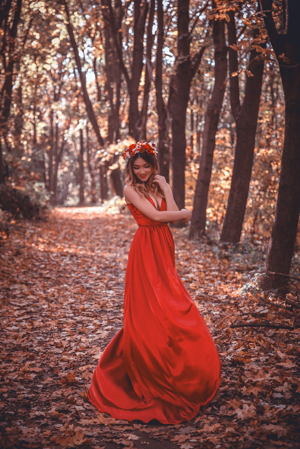 woman in red dress surrounded by trees