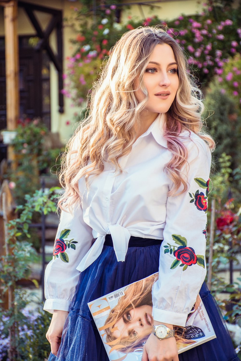 woman in white dress shirt holding book