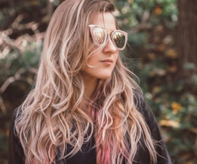 woman wearing sunglasses and leather jacket facing right side