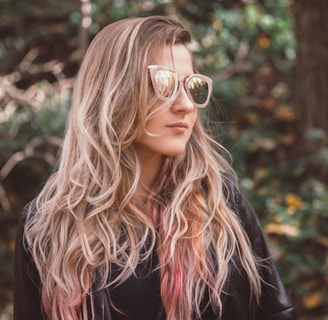 woman wearing sunglasses and leather jacket facing right side