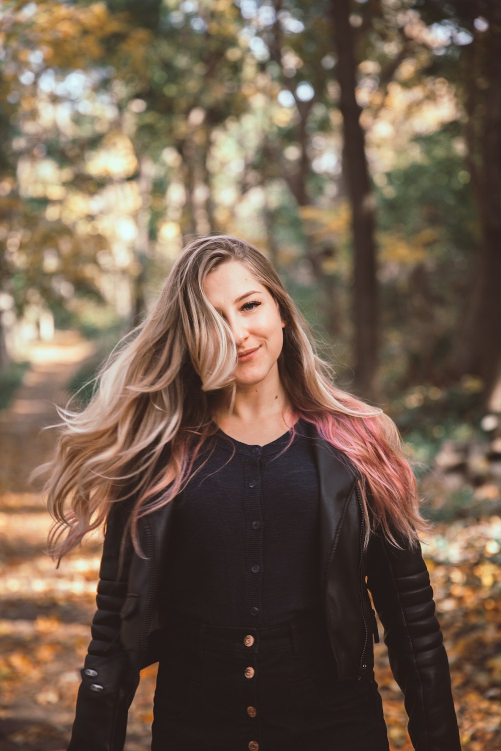 woman in black leather jacket on forest