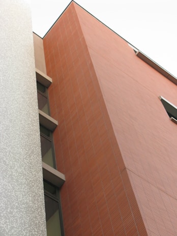 Close-up of modern architectural details showcasing clean edges and burgundy color highlights.