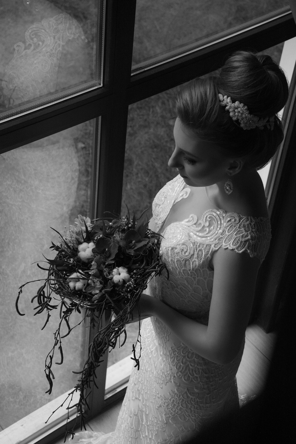 woman wearing white floral wedding dress holding bouquet