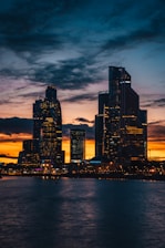buildings beside body of water at golden hour
