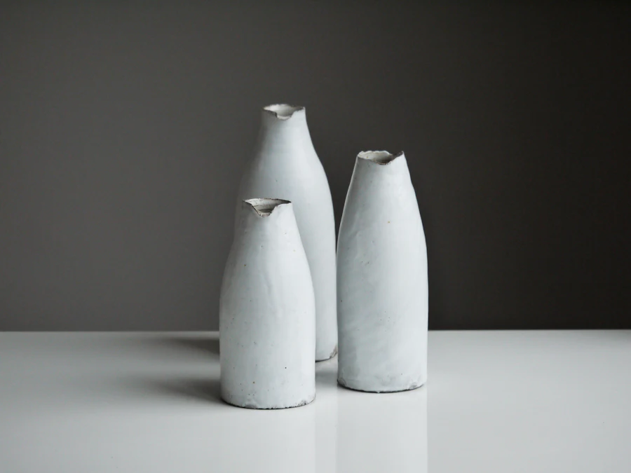 Three white ceramic vases on a table