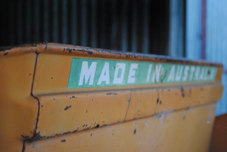 Close-up of a certified building material label with Australian and New Zealand flags in the background.