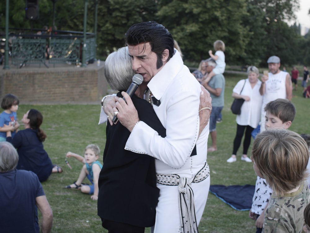 woman hugging man holding microphone