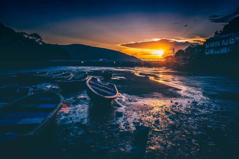 boats on seashore at golden hour
