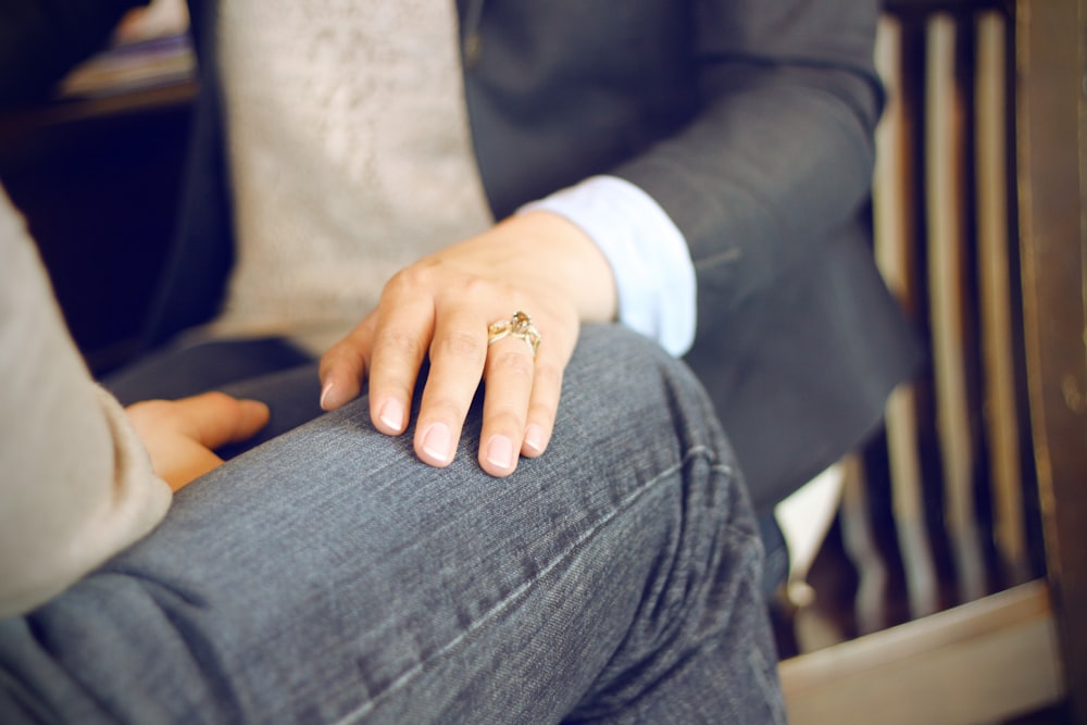 close-up photo of man in front of person sitting on chair