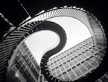 grascale photo of spiral stairs