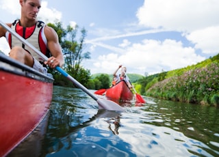 photo of man and woman on kayak paddlings