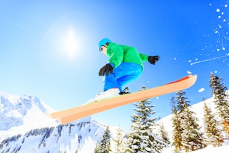 person wearing green jacket riding snow skis
