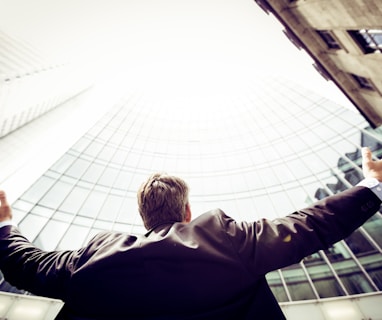 low-angle photography of man in the middle of buidligns