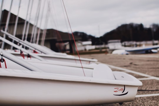 white boat near brown house in Lake Macatawa United States