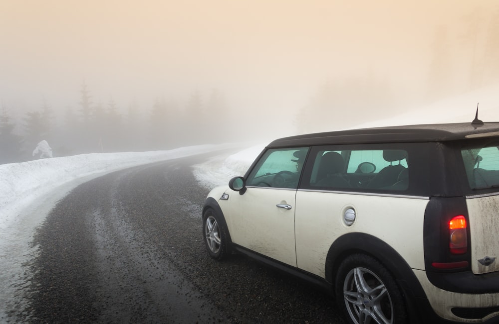 white Mini Cooper in road