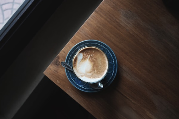 Brown liquid on blue ceramic teacup