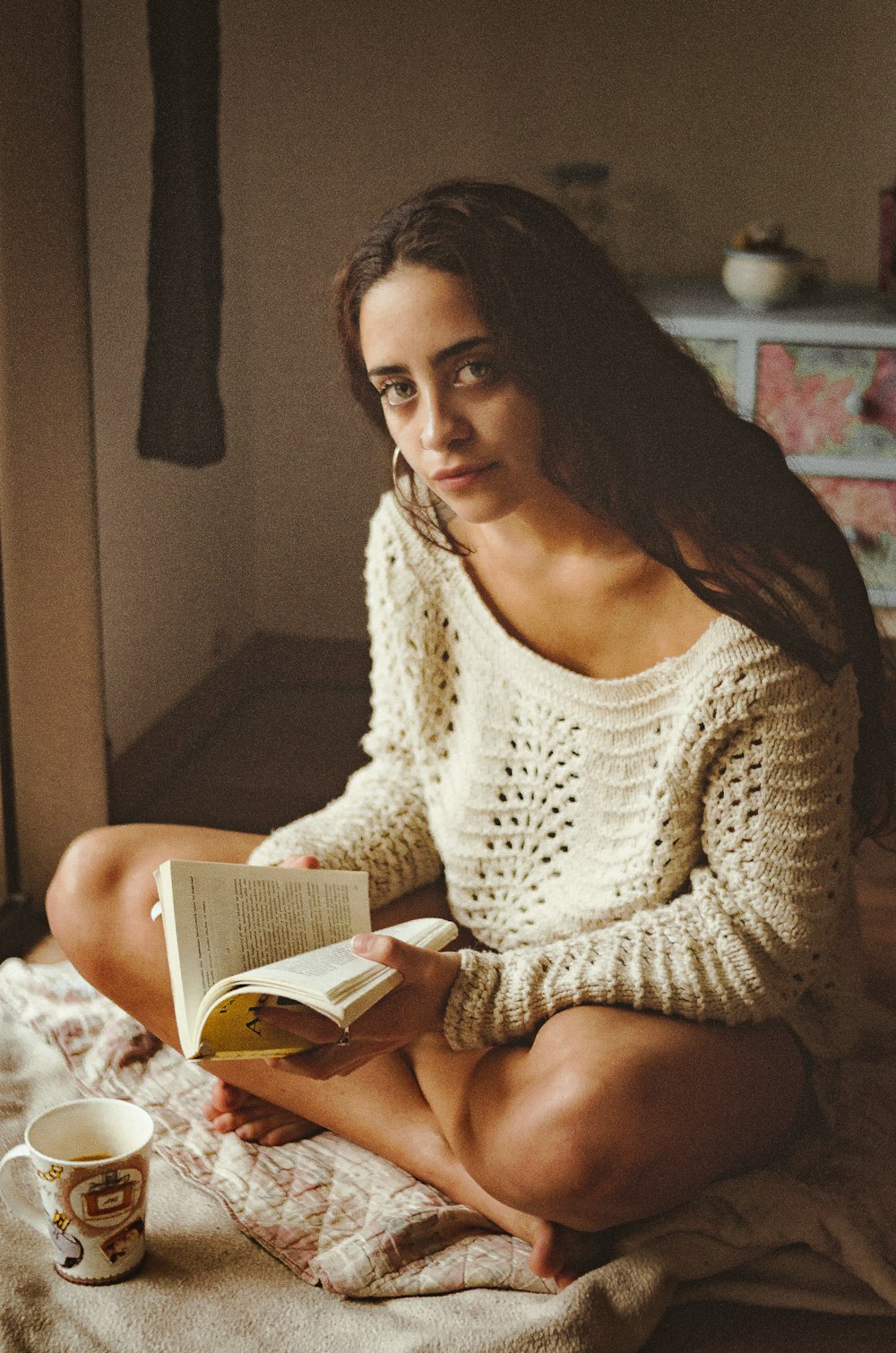 photo of woman holding book