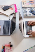 person typing on silver laptop computer