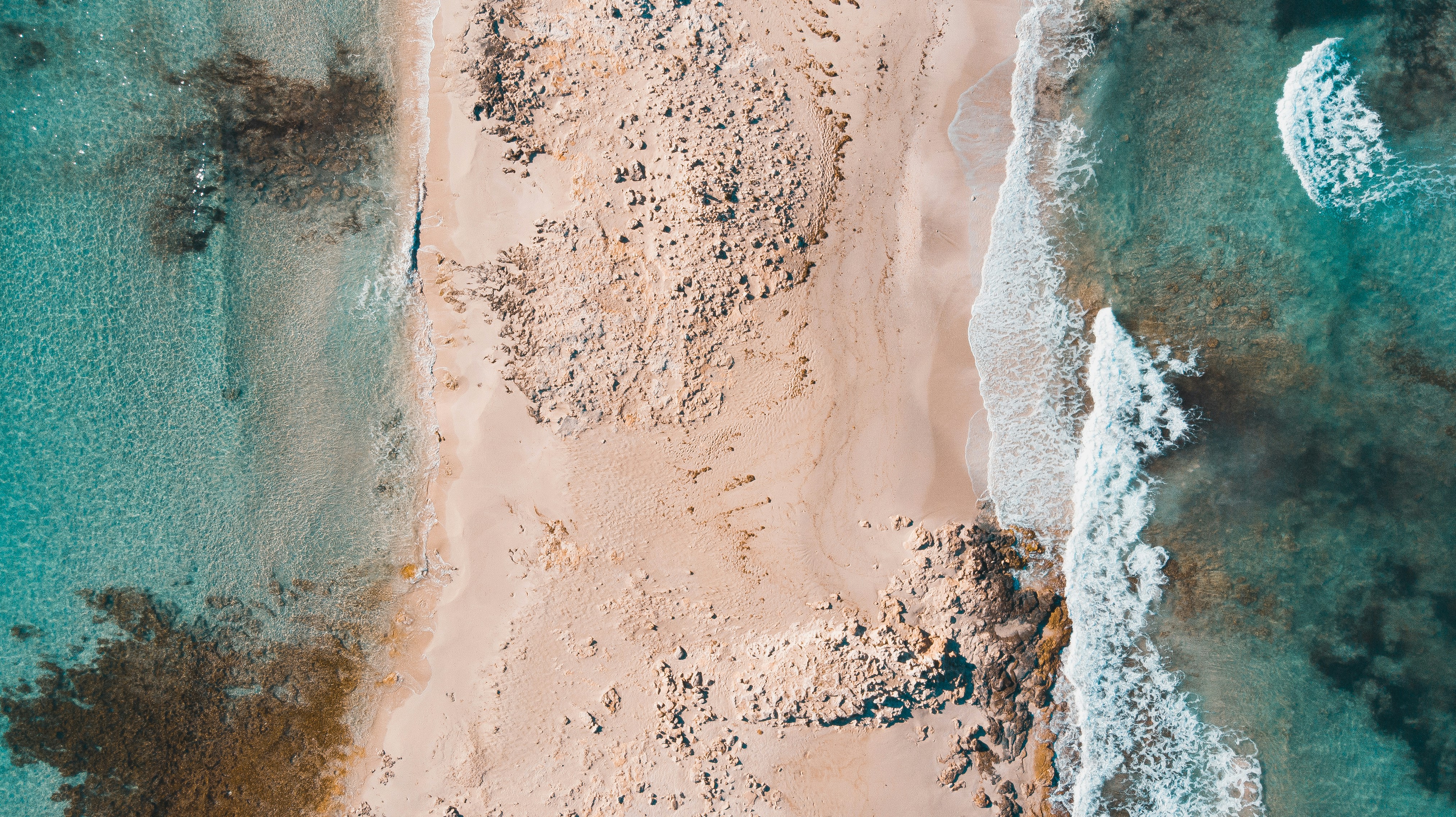 aerial photography of sand between sea