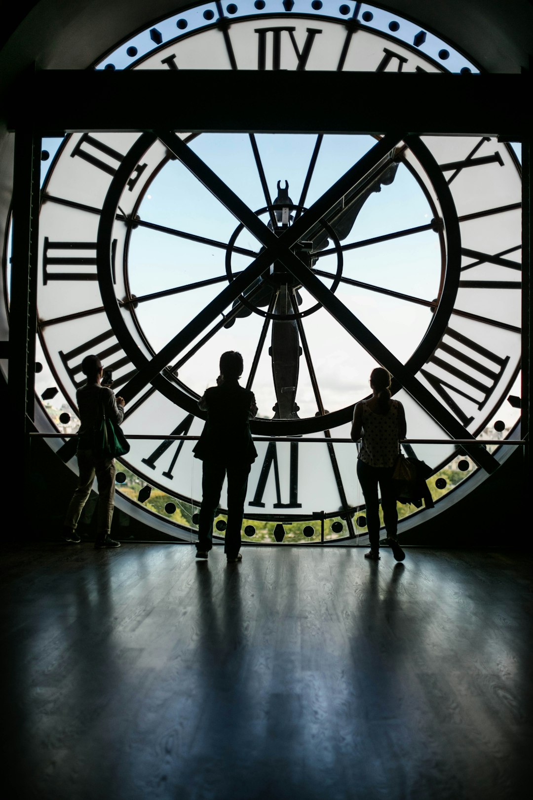 three people standing inside Big Ben building