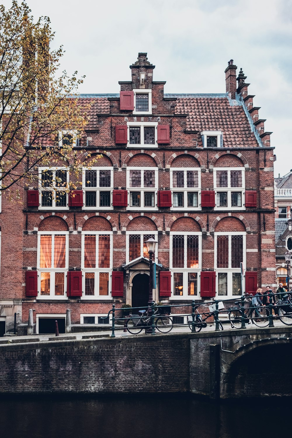 photo of parked bicycles near red concrete house