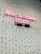 A pink neon sign with the text 'PEOPLE FAIL FORWARD TO SUCCESS' mounted on a white brick wall. The bricks are uniform in size and the wall is clean and well-maintained.