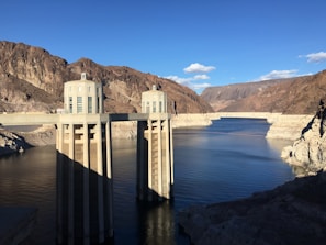 Engineers monitoring reservoir data on screens inside a control room.