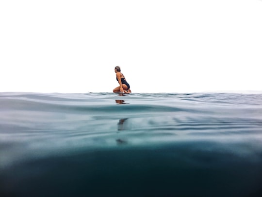 woman surfing on sea in Encinitas United States